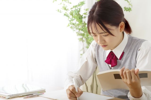 部屋で勉強している学生